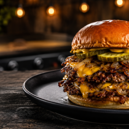 Juicy stacked cheeseburger on rustic plate