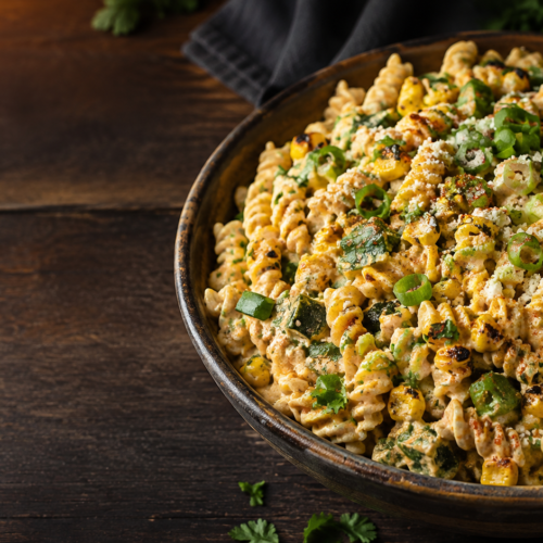 Grilled street corn pasta salad in a serving bowl
