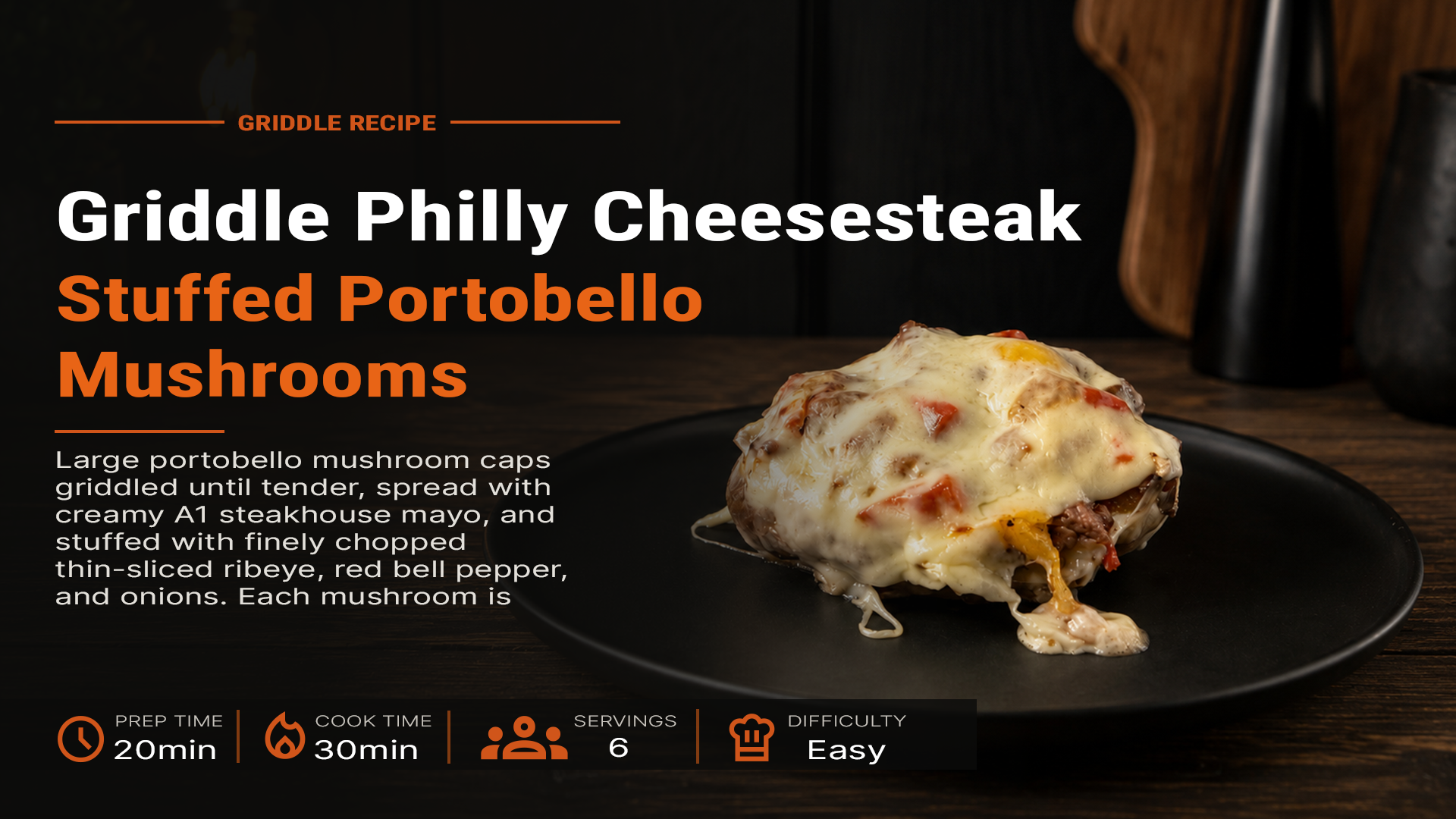 Philly cheesesteak stuffed portobello mushroom topped with melted cheese and peppers on a black plate over a rustic wood table.